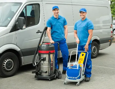 Business Cleaning Company employees smiling next to their fleet vehicle