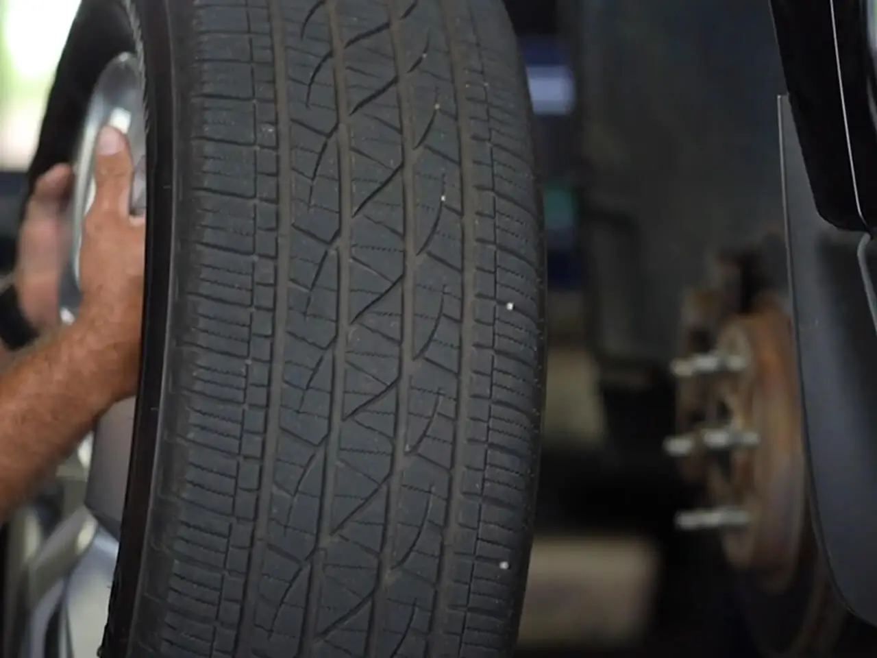 Grease Pro Tire and Auto Repair Services - Tire Tread shown while Wheel is replaced on vehicle for service