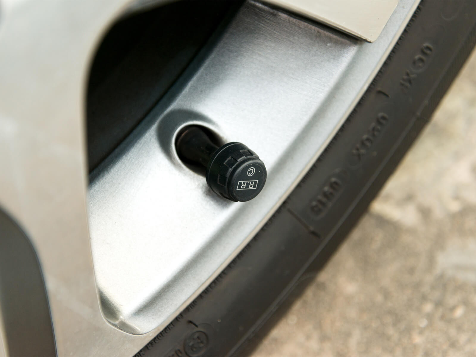 A car tire tpms sensor on an suv wheel valve cap